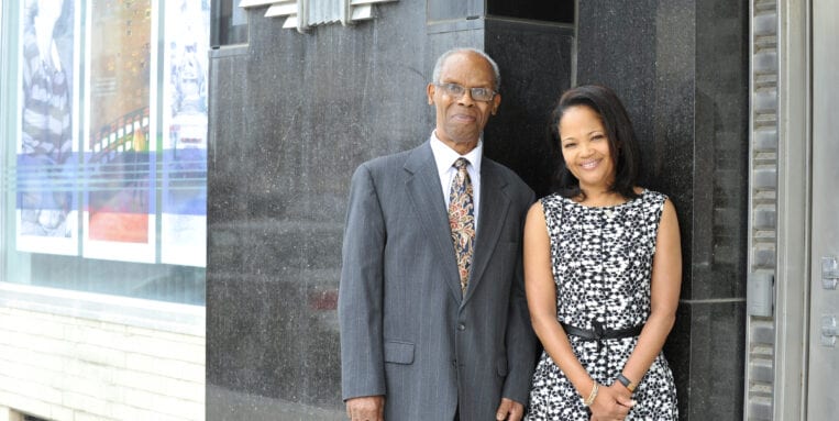 Marshall Nelson stands with Melanie Johnson in front of the National Grid Building