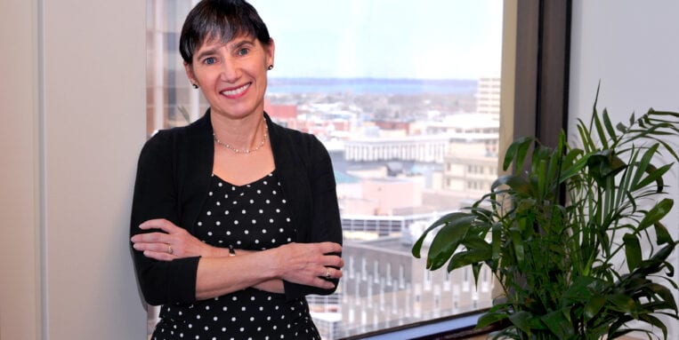Rita Reicher stands in her office in the AXA Towers