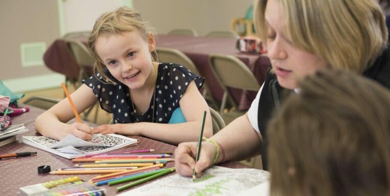 Children color at a table at the Cortland Salvation Army