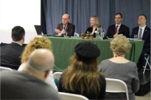 Panel members sitting in front of an audience