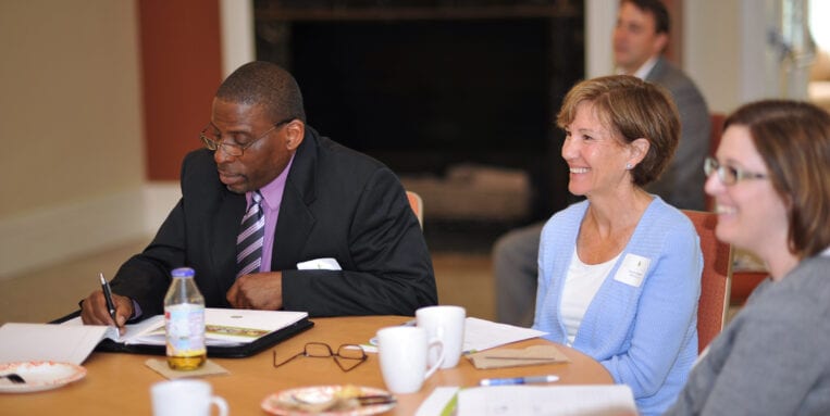 Attendees sit at table at the NEWS Workshop.