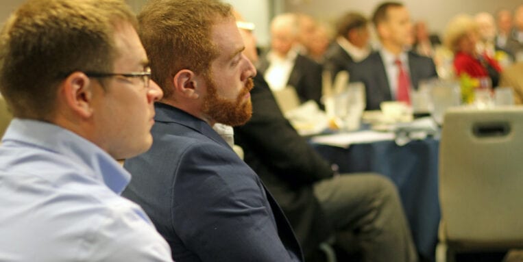 Participants sit around tables at the annual continuing education event