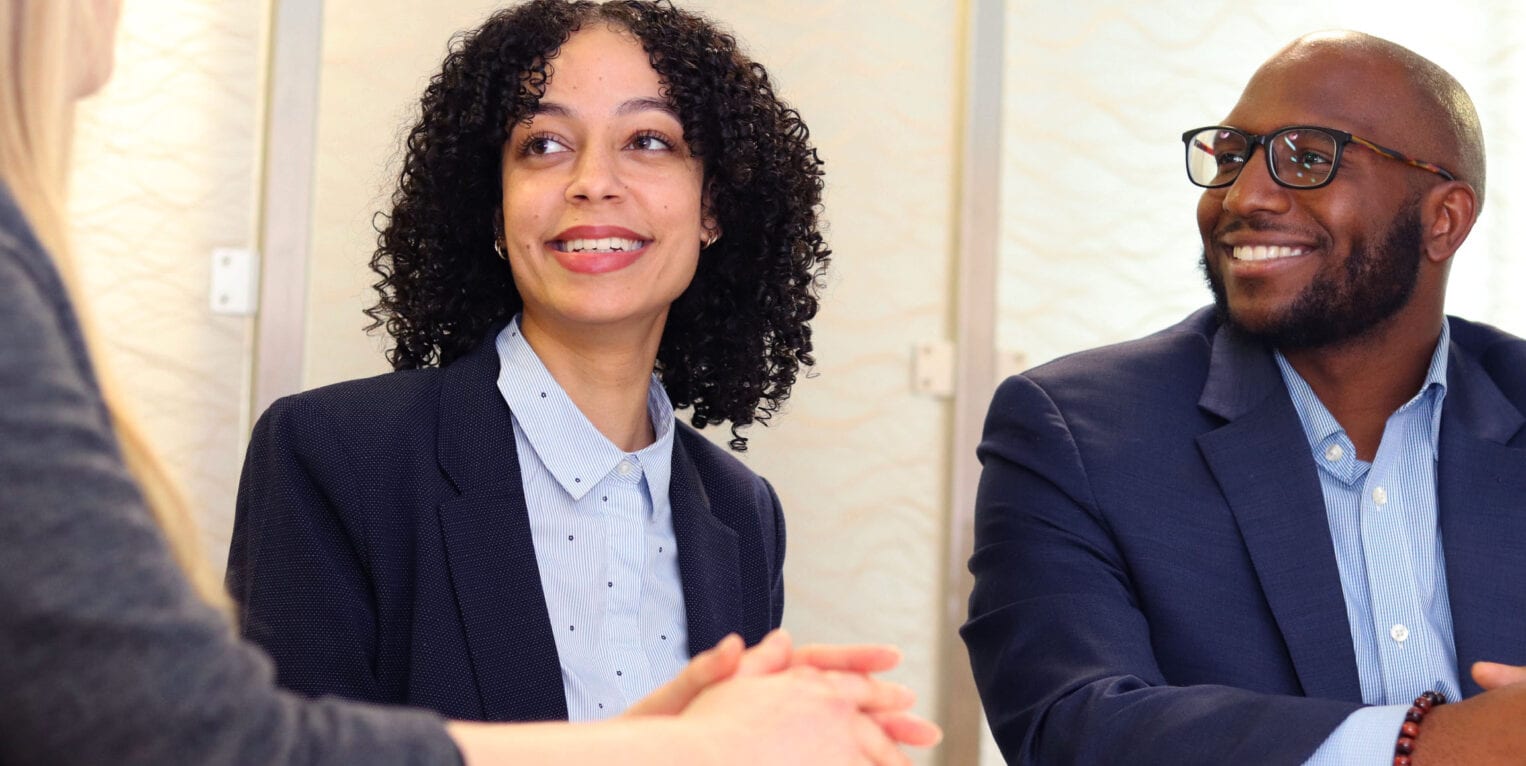 Black female and male sitting at table and talking