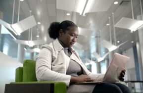 A Say Yes Scholar works on a laptop at Syracuse University