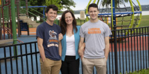 Caragh Fahy and her two sons stand in from of a playground