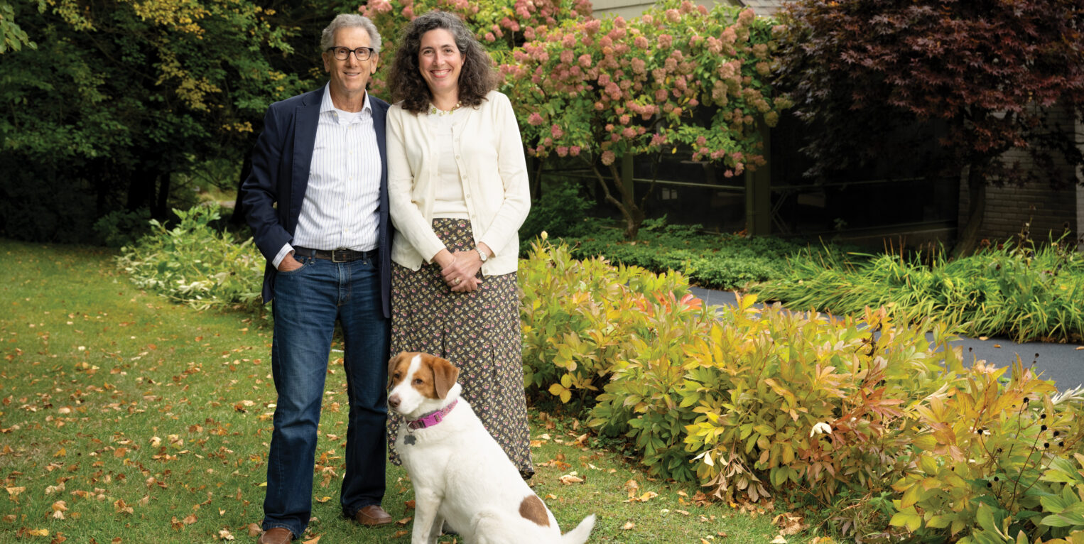 Man and woman standing with their dog