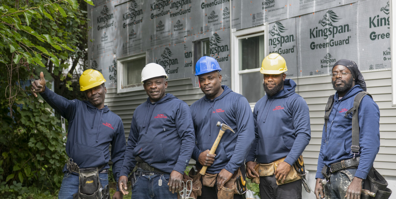 Group of construction men standing in front of house