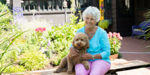 Pamela Monaco sitting with her dog